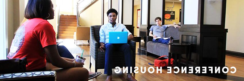 People working on laptops in common area.