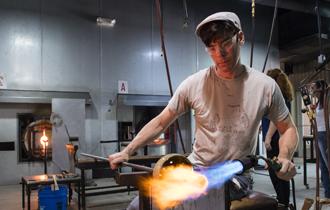 USA associate professor Matthew Patterson refines his glass art project.